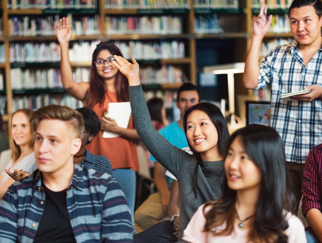 students raising hands to ask questions