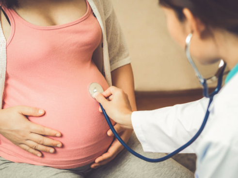 doctor checking pregnant woman